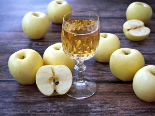 Apple juice and yellow apples fruit on wooden background	