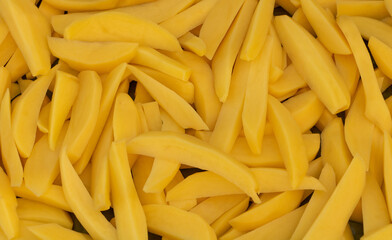 Sliced potatoes raw texture background. In the process of cooking potatoes