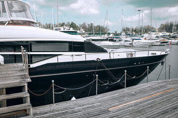 Fototapeta premium Front of a luxury yacht parked in the parking lot on the water, sharp nose of the yacht