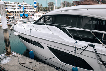 Huge beautiful expensive black and white yacht parked in a parking space.
