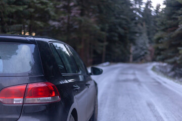 A modern car on an icy mountain road.