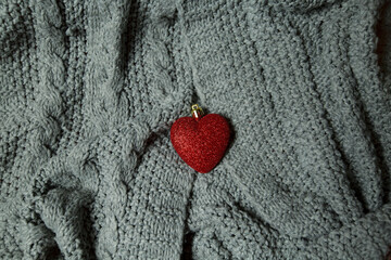 red heart on gray knitted fabric