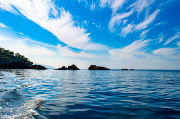 Sea view from speedboat with island, rocks and waves