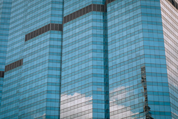 Spectacular glass high-rise building in which the amazing sky is reflected, background