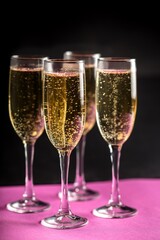 Foour Champagne Glasses on Black Background