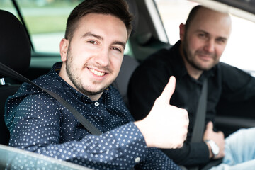 Man Getting a Driving Lesson and Showing Thumbs-up