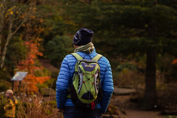 hiker with backpack walking in the forest