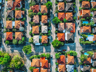 Aerial top view villages with orange roofs and gardens with nature green on the outskirts of the city