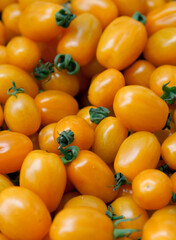 Top view of ripe small yellow tomatoes. Organic garden vegetables. Harvest  and healthy food concept.