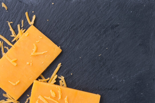 Cheddar Cheese With Crumbs On Marble Background