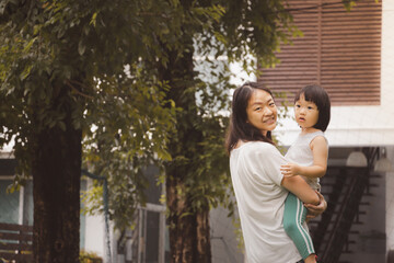  Asian 3 year old kid and mom in park. Background for  funny life and family play time.