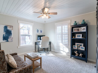 Home office, plantation shutters, natural light, shelves, white chair
