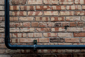 Metal pipe on brick wall