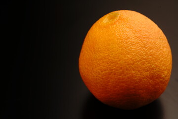 Orange on a black background. The light was dim. Bright colors. Close.