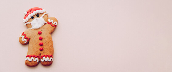 Xmas set of cookies, gingerbread man in face mask, gingerman in a protective mask on a white snow background, minimal seasonal pandemic winter holiday banner