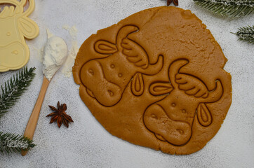 making homemade cookies from dough in the shape of the symbol of the year cow or bull, home hobby during quarantine baking concept