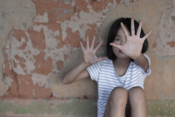 little girl with her hand extended signaling to stop against violence,