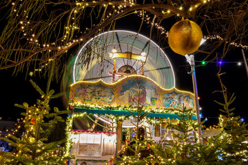 Graz, Austria - November 29, 2019: Vintage carousel and beautiful Christmas decorations at night, in the city center of Graz, Styria region, Austria