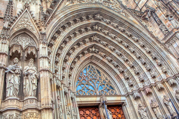 Fototapeta premium Doorway details of Cathedral of Barcelona . Entrance of Imposing Gothic cathedral in Catalunya
