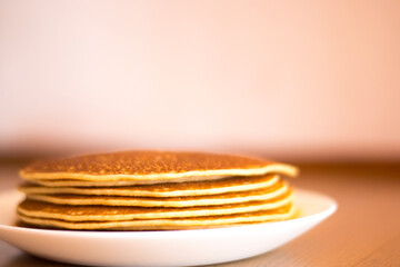 Small pancakes on a white plate.