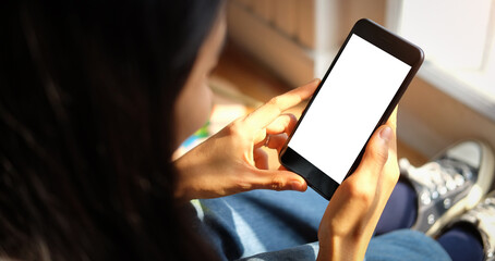Close up view of male hands using smart phone with modern office blurred background. Blank screen monitor for graphic display montage.