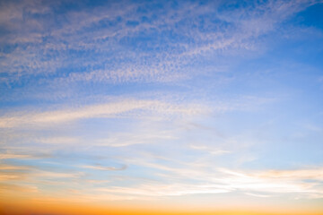 Fototapeta premium Blue sky with white and yellow clouds at sunset background
