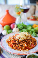Muslim Ramadan iftar family dinner. Flat-lay of people feasting over table with Middle East food. Dates, dolma, kebab, flatbread, pide, borek, sweet, salad, top view. Ramazan fasting Turkish cuisine.