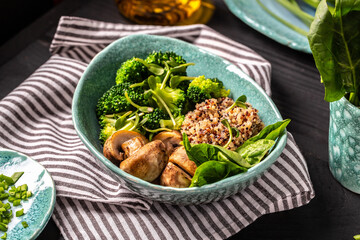 Fresh Vegetable salad quinoa, spinach and mushrooms in a bowl. Clean eating, dieting