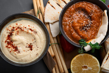 Different kinds of hummus dips with snacks