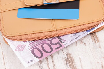 Currencies euro and credit card with leather wallet. Choice between cashless or cash payment