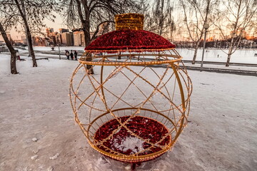 Decorations of the city Park in the form of Christmas balls with lighting in the evening