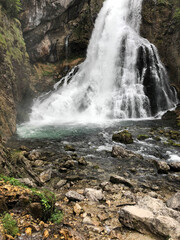 the most beautiful waterfall among the trees in the forest in austria