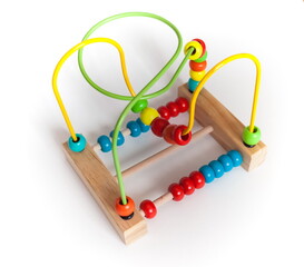 Colored purchased children's toy made of painted wood and metal close up on a white background