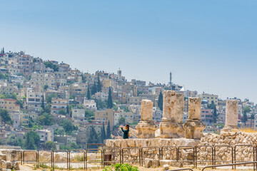 Naklejka premium Cityscape of Amman with numerous buildings, the capital and most populous city of Jordan, view from Amman Citadel, known in Arabic as Jabal al-Qal'a.
