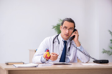 Young male doctor cardiologist working in the clinic