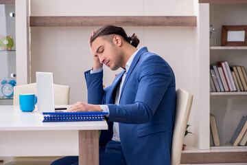 Young male employee working from the house