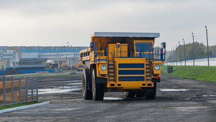 Giant mining truck after being from the conveyor is tested at the factory test site. Heavy-duty truck manufacture by the heavy vehicle plant. Production of heavy mining dump trucks.