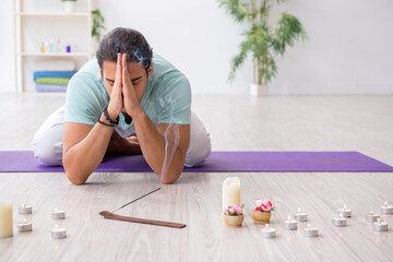 Young man during yoga session at home