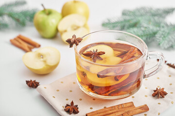 Christmas cup drink background. Tea with cinnamon, apple and star anise. Happy New Year and Merry Christmas greeting card. Cozy morning. Traditional medicine and vitamins. Healthy food