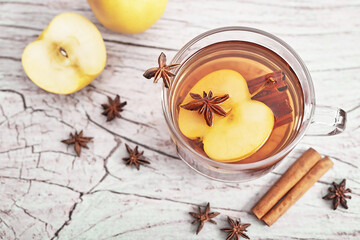 Christmas cup drink background. Tea with cinnamon, apple and star anise. Happy New Year and Merry Christmas greeting card. Cozy morning. Traditional medicine and vitamins. Healthy food