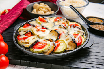Baking dish with tasty rice casserole on table
