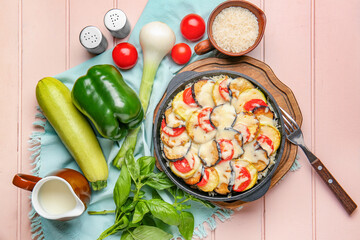 Baking dish with tasty rice casserole on table