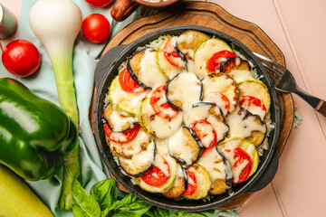 Baking dish with tasty rice casserole on table