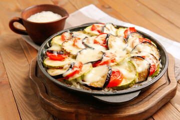 Baking dish with tasty rice casserole on table