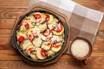 Baking dish with tasty rice casserole on table