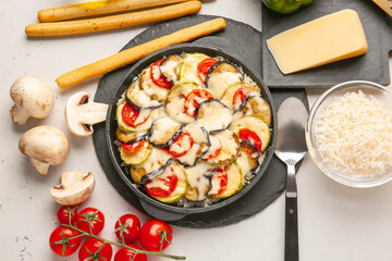 Baking dish with tasty rice casserole on table