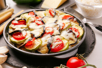 Baking dish with tasty rice casserole on table