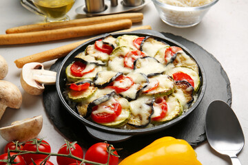 Baking dish with tasty rice casserole on table
