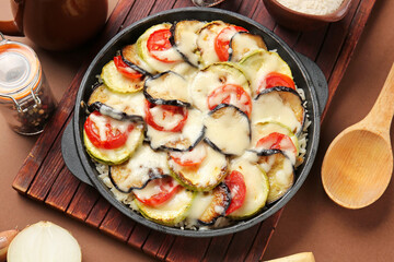 Baking dish with tasty rice casserole on table