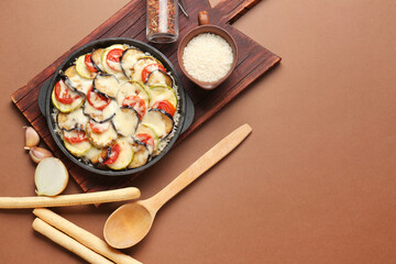 Baking dish with tasty rice casserole on color background